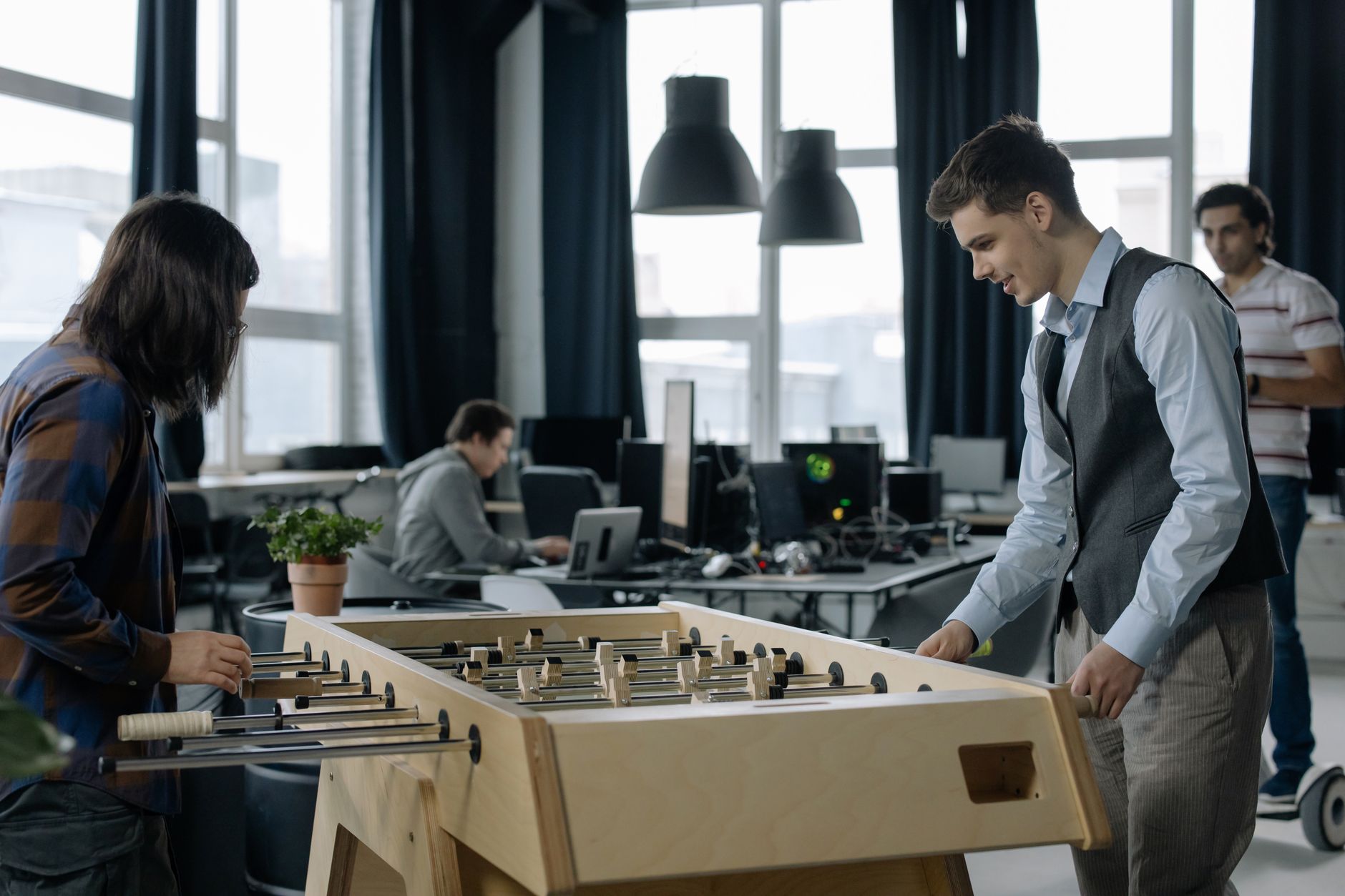 Small team working at computers in a modern startup office space