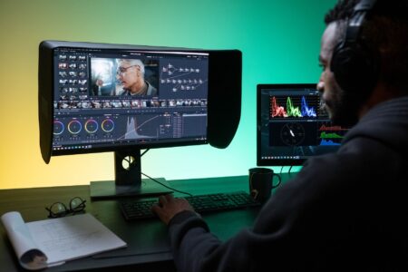 A professional video editing setup with multiple monitors showing timeline software