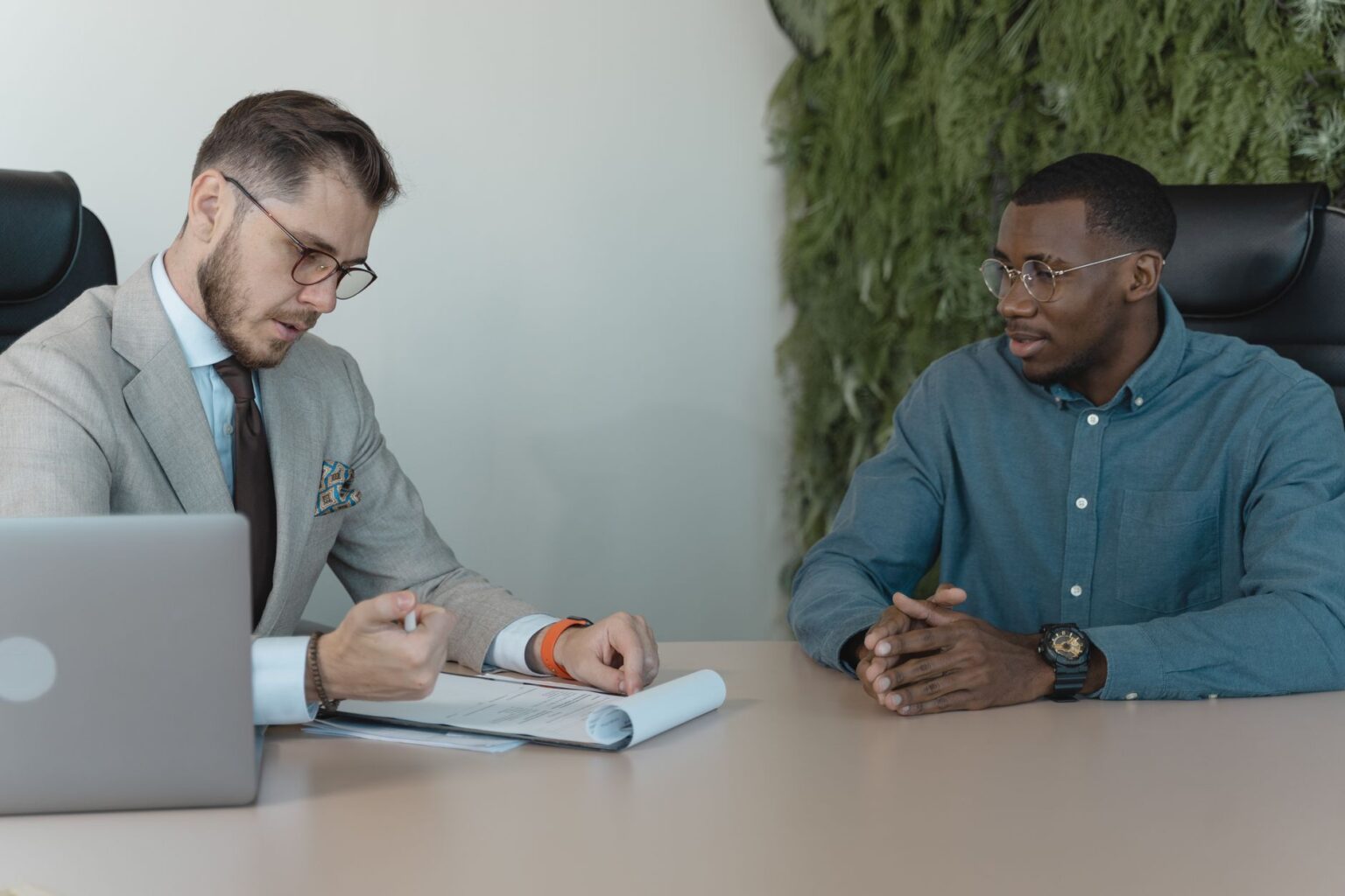 Two professionals conducting a job interview in a modern office setting