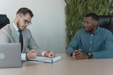 Two professionals conducting a job interview in a modern office setting