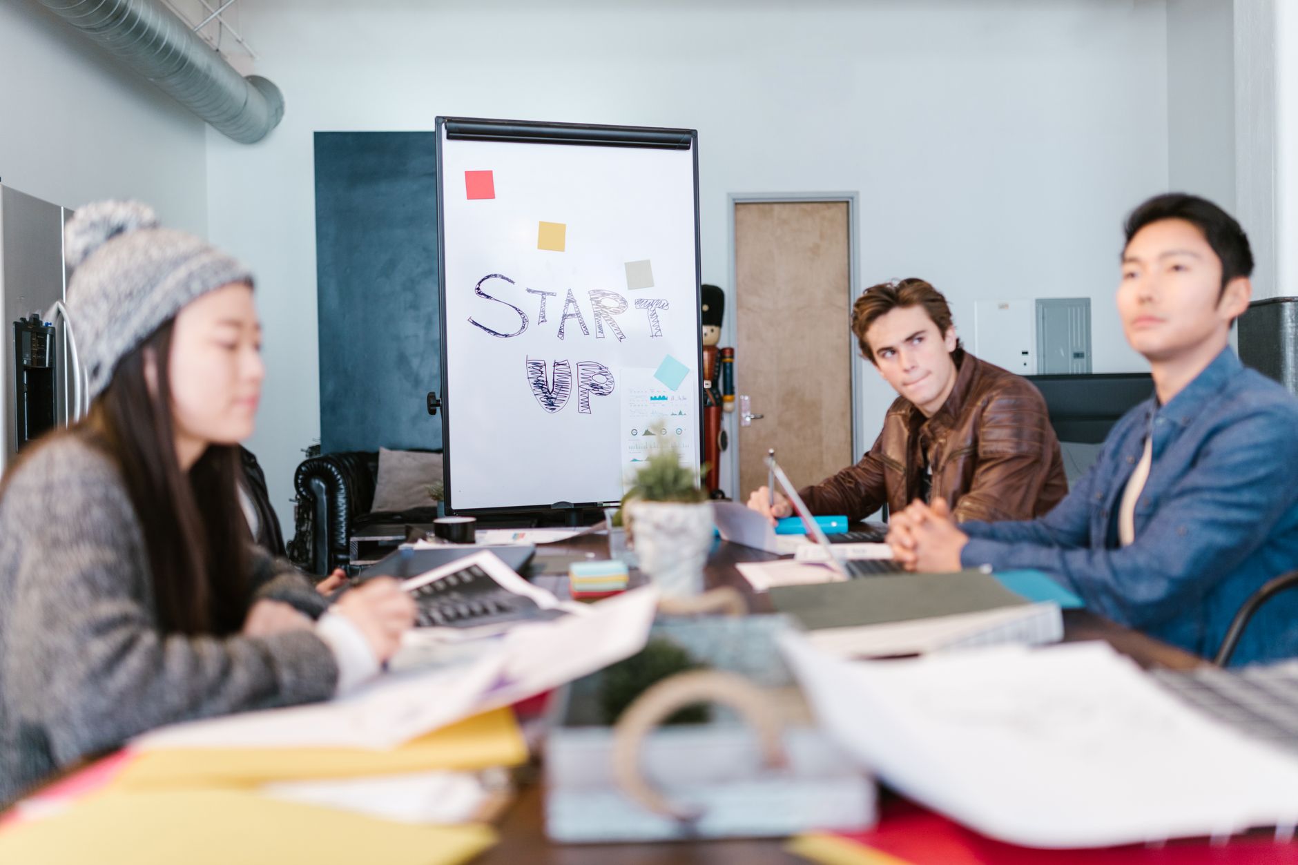 Small startup team reviewing candidates on laptops in an open workspace