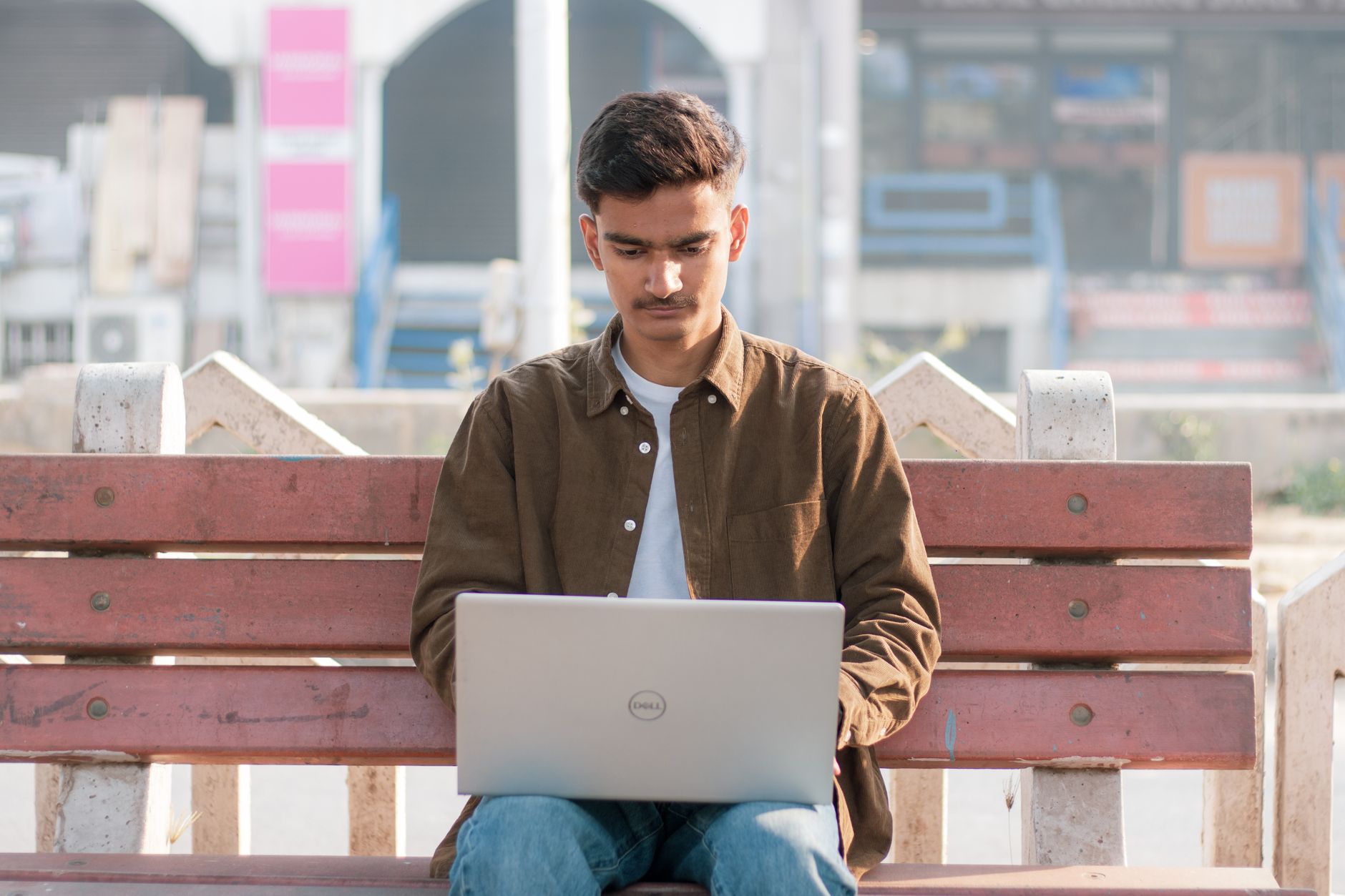 A content creator working on a laptop in a modern workspace