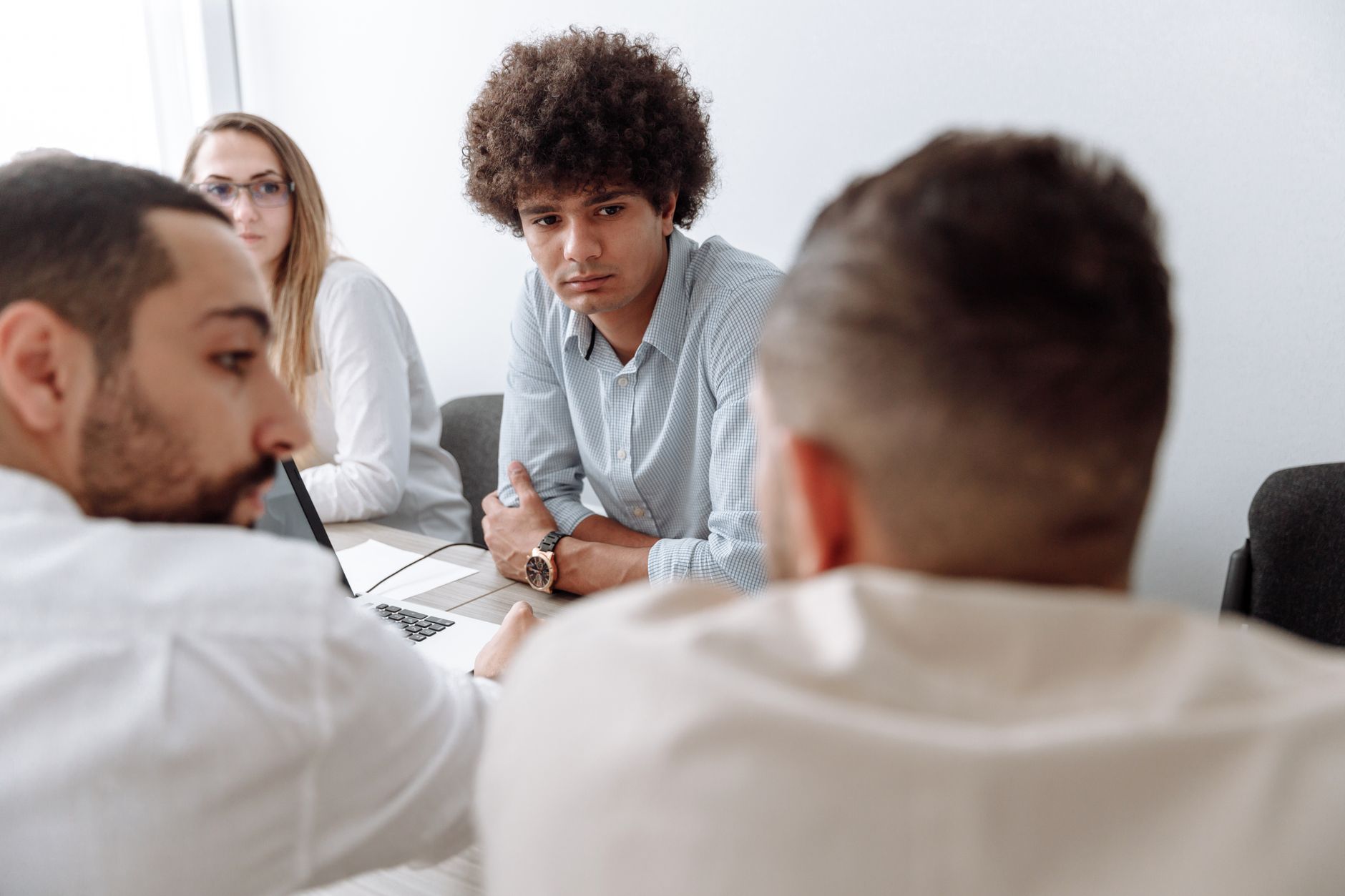 Small team of professionals discussing a digital product strategy around a table